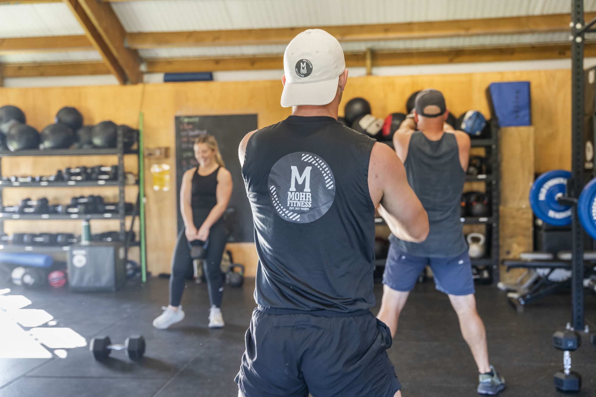 Members training with kettlebells in a Mohr Fitness class